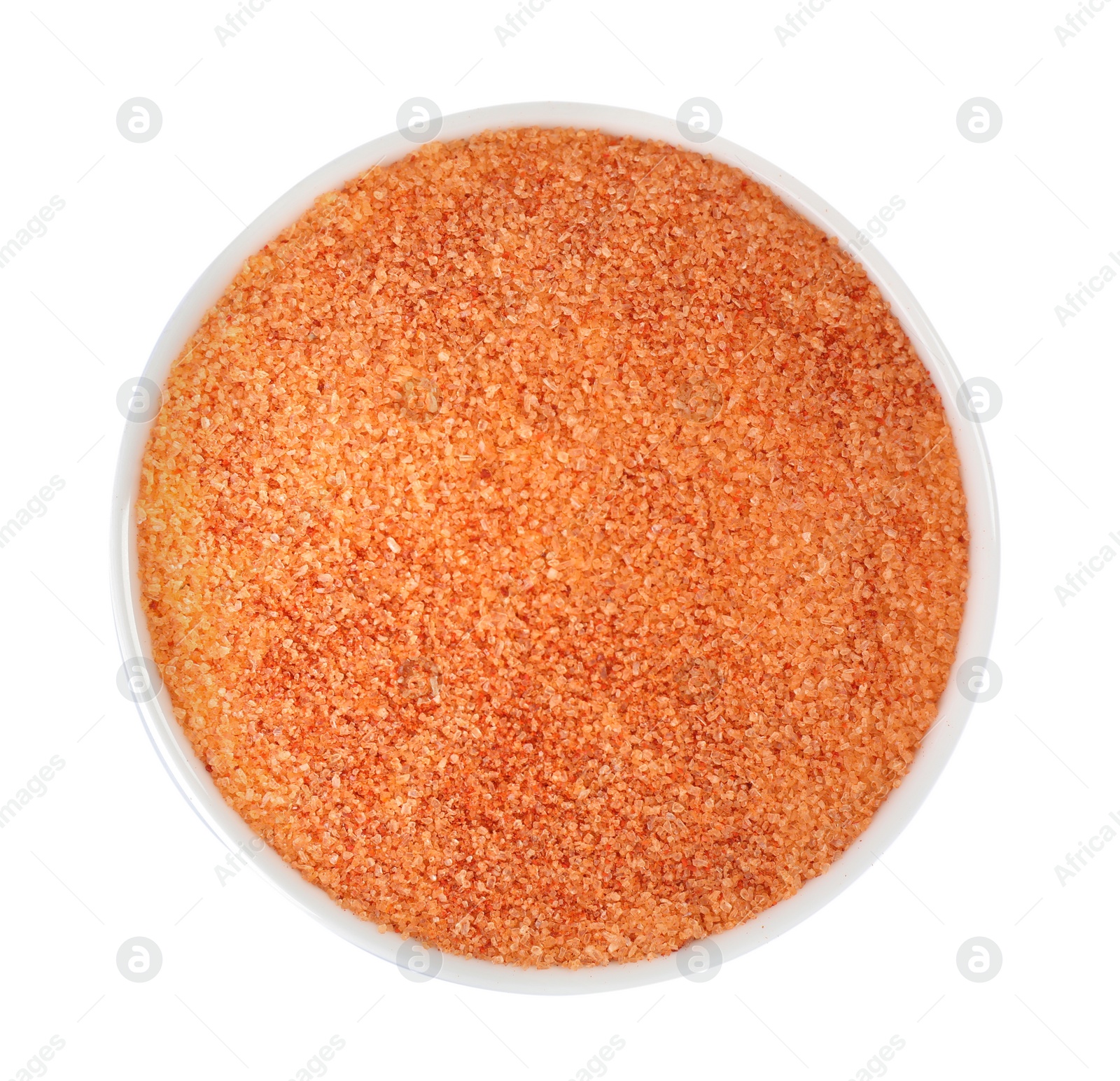 Photo of Orange salt in bowl isolated on white, top view