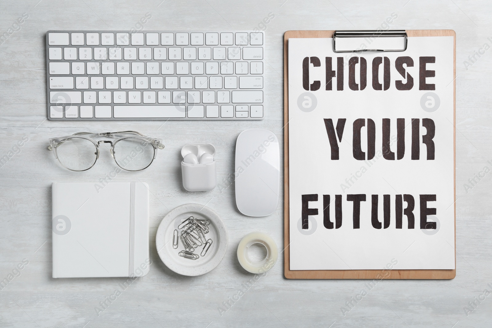 Photo of Flat lay composition with words CHOOSE YOUR FUTURE, computer keyboard and stationery on white wooden table. Career concept