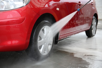 Cleaning vehicle with high pressure water jet at car wash