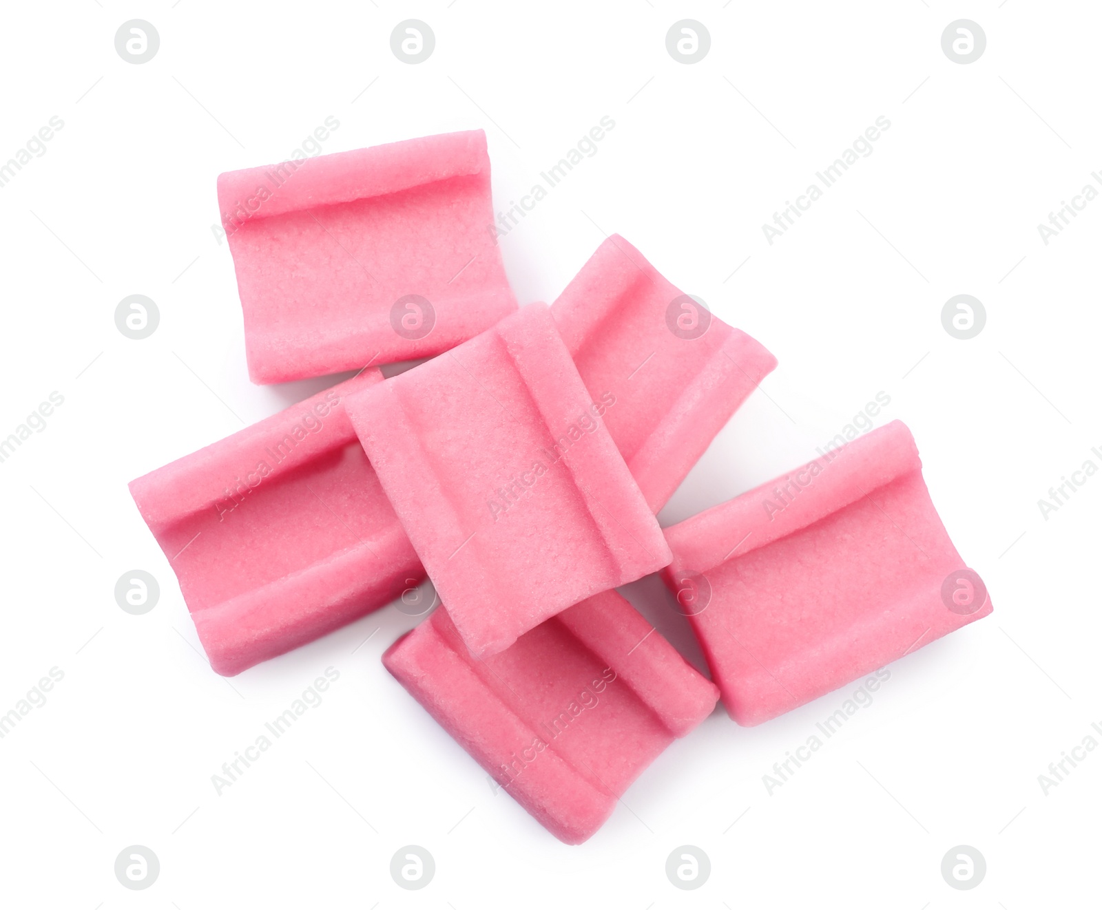 Photo of Tasty pink chewing gums on white background, top view