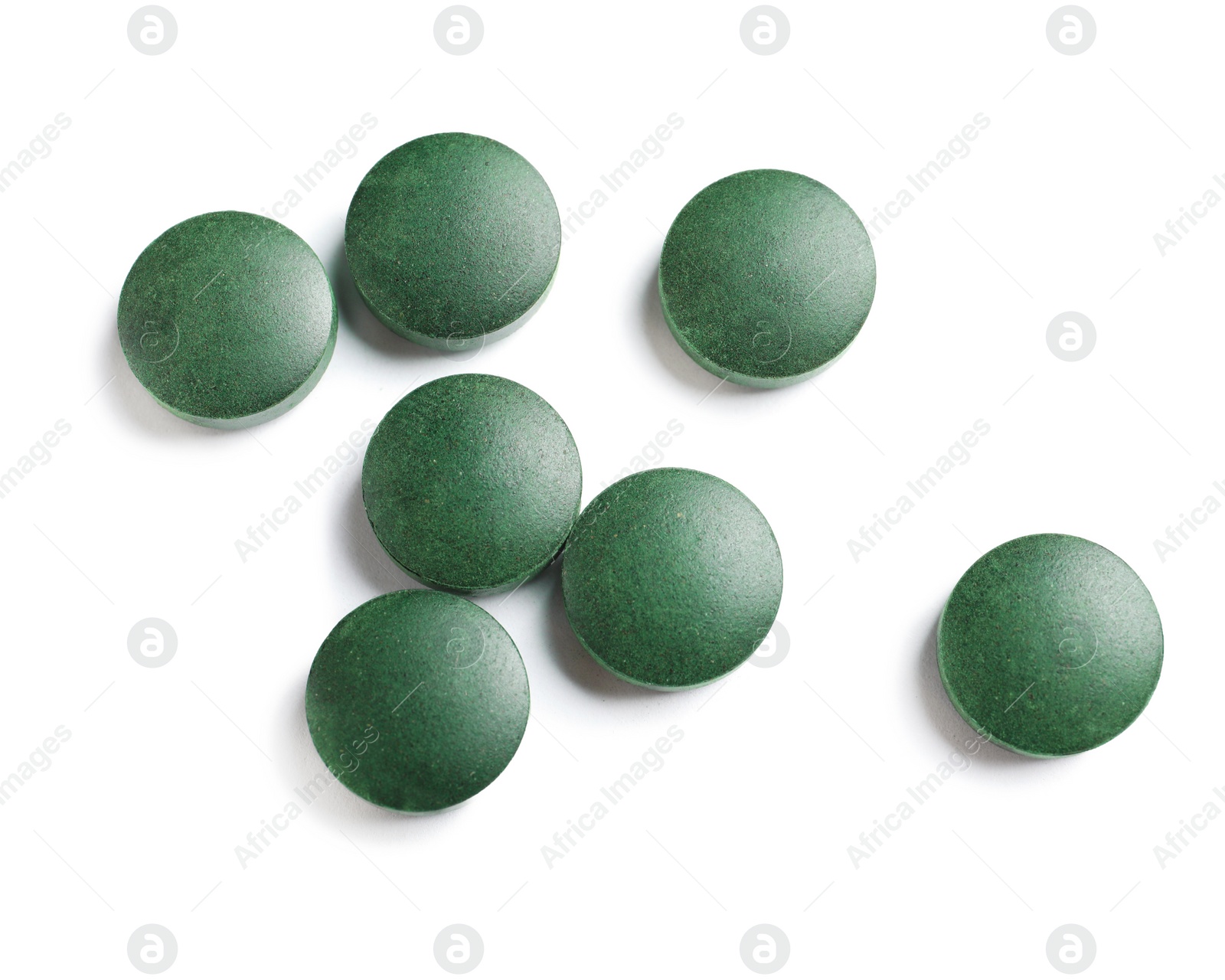 Photo of Spirulina tablets on white background, top view. Healthy lifestyle