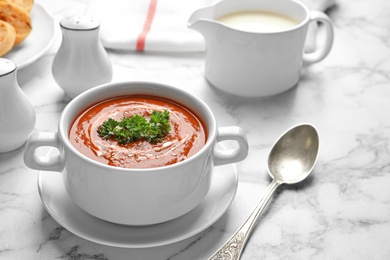 Photo of Dish with fresh homemade tomato soup on marble table. Space for text