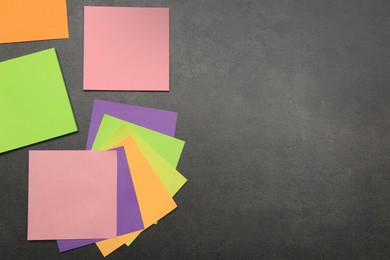 Colorful stickers on grey stone table, flat lay. Space for text