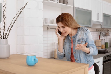 Photo of Woman arguing on mobile phone at home