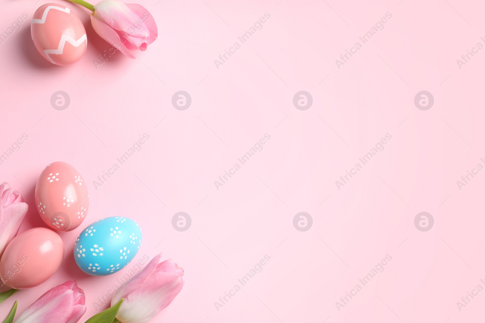 Photo of Flat lay composition with painted Easter eggs on color background, space for text