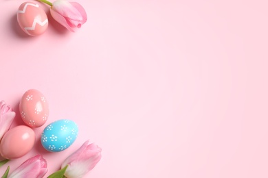 Photo of Flat lay composition with painted Easter eggs on color background, space for text