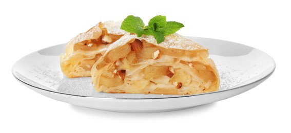 Photo of Pieces of delicious apple strudel with almonds, powdered sugar and mint on white background