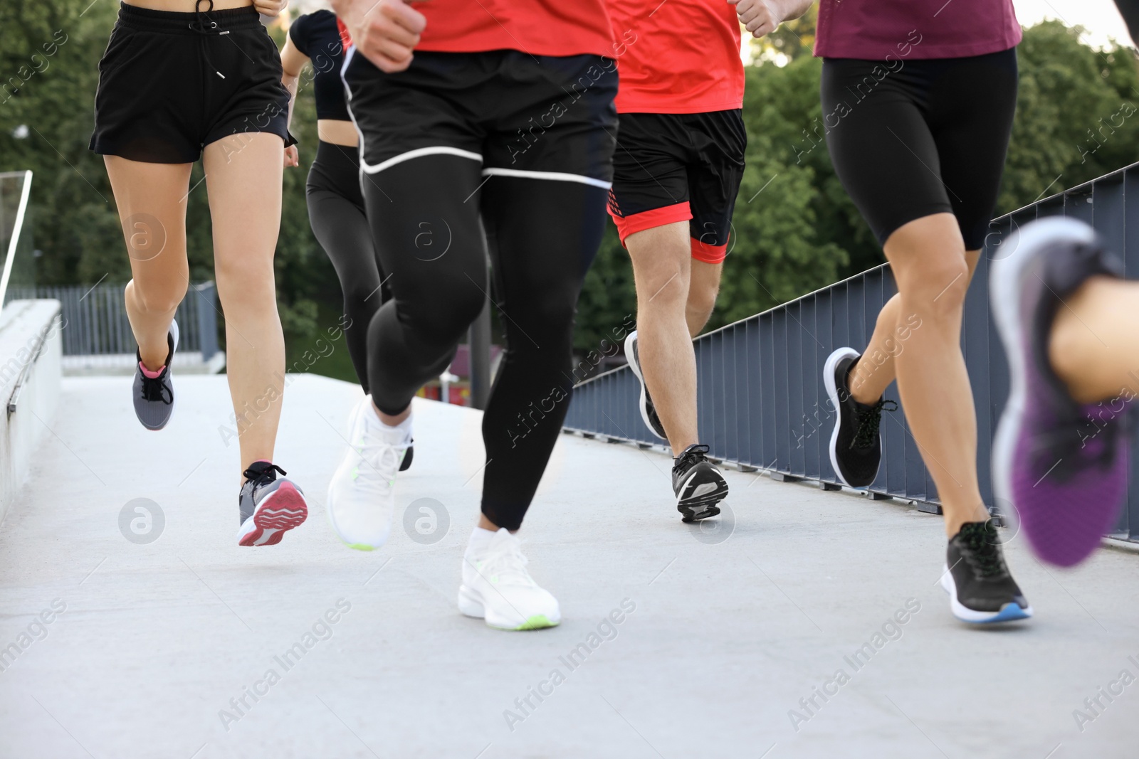 Photo of Group of people running outdoors, closeup view