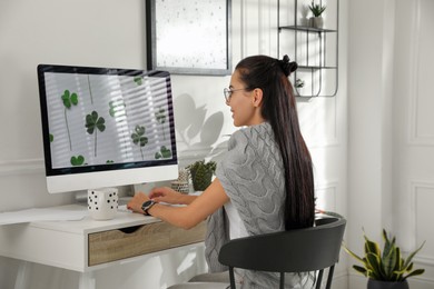 Young woman working at table in light room. Home office