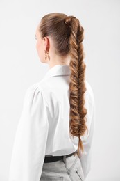 Photo of Woman with braided hair on light background