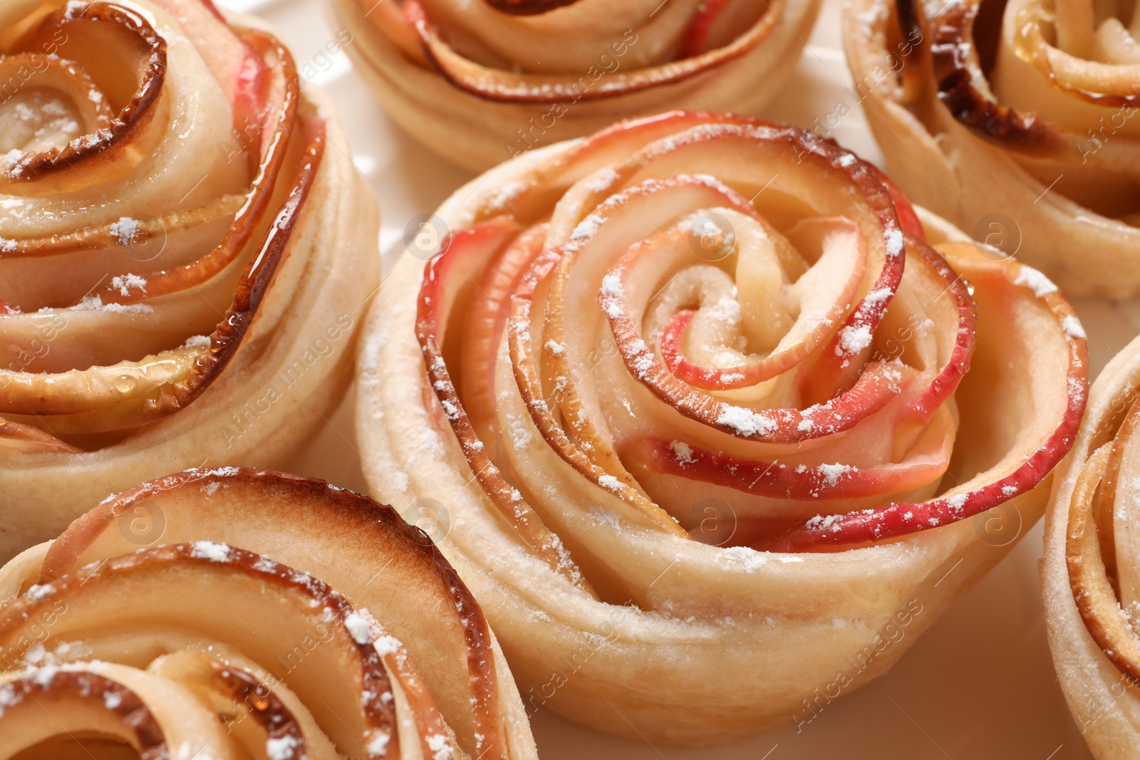 Photo of Freshly baked apple roses, closeup. Beautiful dessert