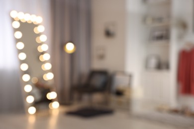 Blurred view of makeup room with stylish mirror