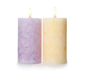 Photo of Alight color wax candles on white background