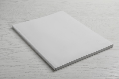 Photo of Brochure with blank cover on wooden background. Mock up for design