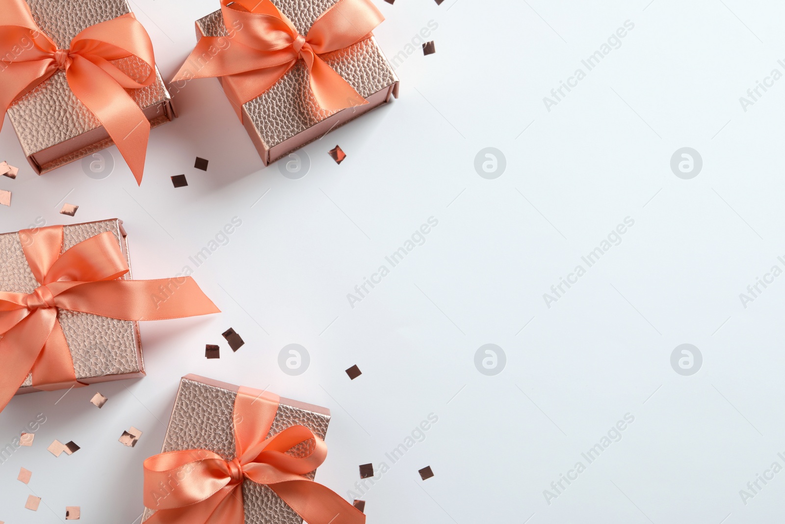 Photo of Beautiful gift boxes and confetti on white background, flat lay. Space for text