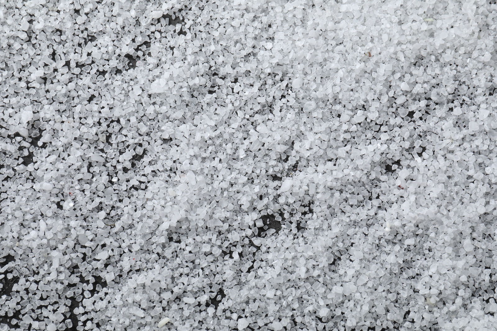 Photo of White natural salt as background, top view