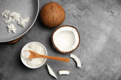 Photo of Flat lay composition with coconut oil and nut pieces on grey background