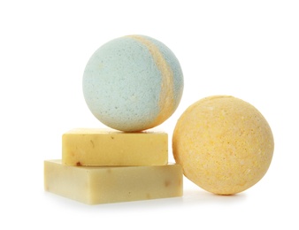 Photo of Bath bombs and soap bars on white background