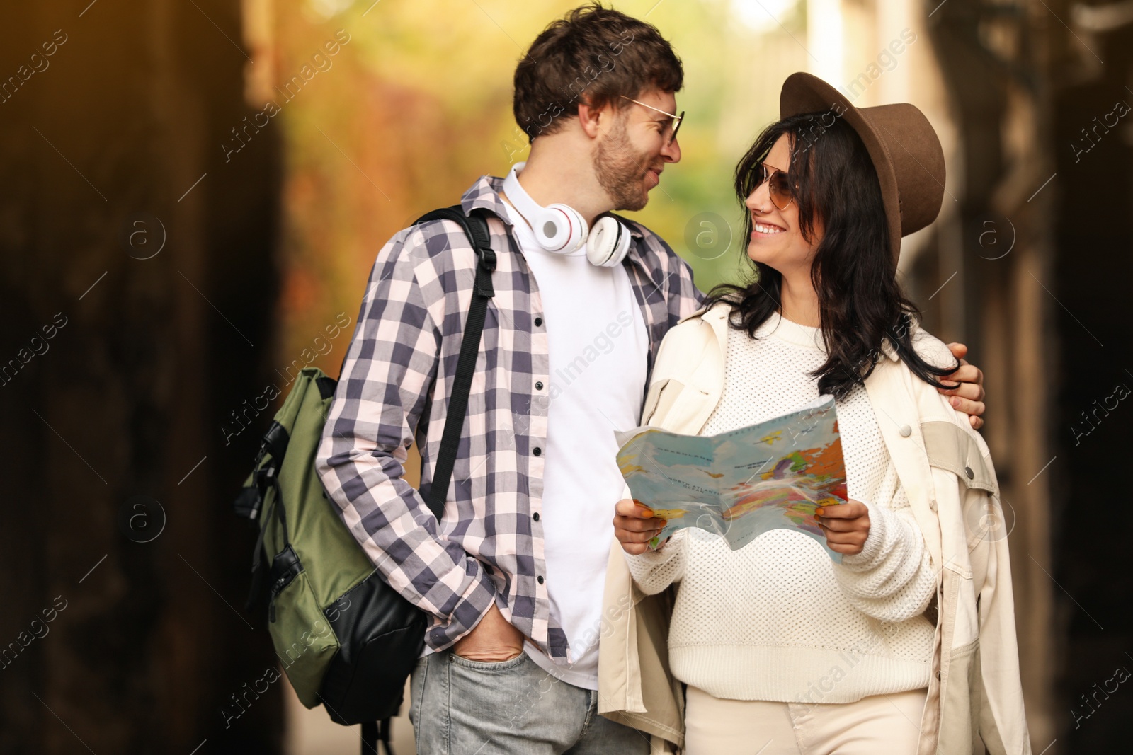 Photo of Couple of travelers with map on city street