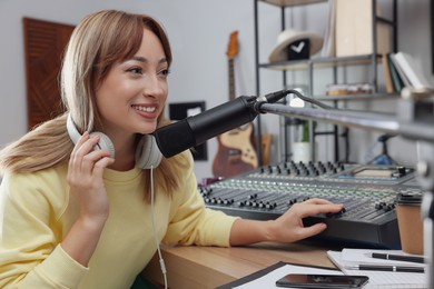 Woman working as radio host in modern studio