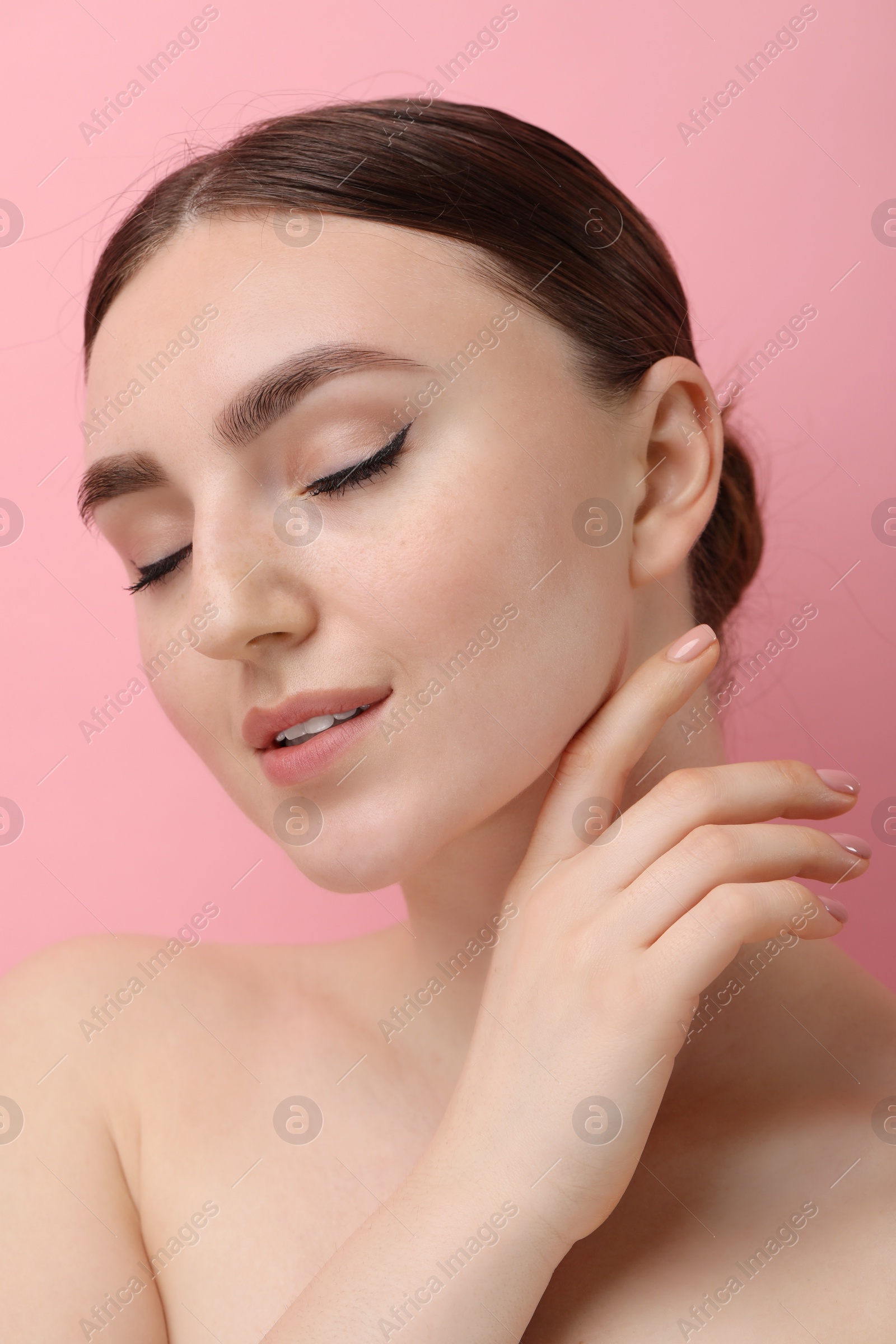 Photo of Makeup product. Woman with black eyeliner and beautiful eyebrows on pink background