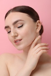 Makeup product. Woman with black eyeliner and beautiful eyebrows on pink background