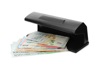 Modern currency detector with Euro banknotes on white background. Money examination device