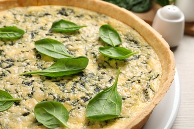 Delicious homemade spinach pie on table, closeup