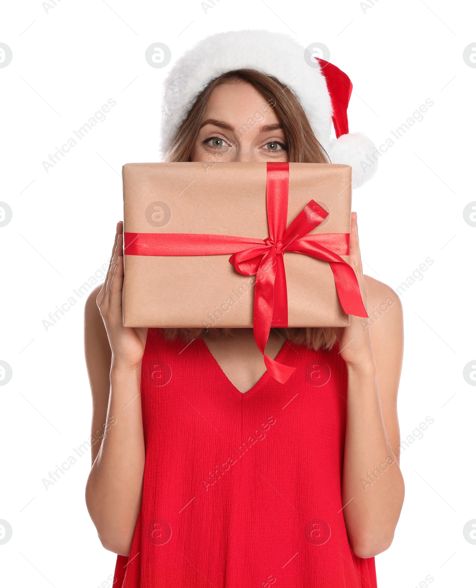 Photo of Happy young woman in Santa hat with gift box on white background. Christmas celebration