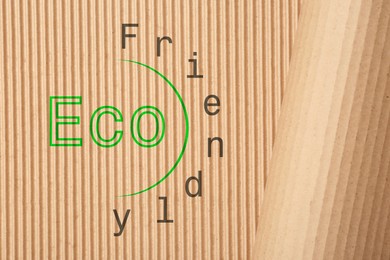 Phrase Eco Friendly written on cardboard, top view