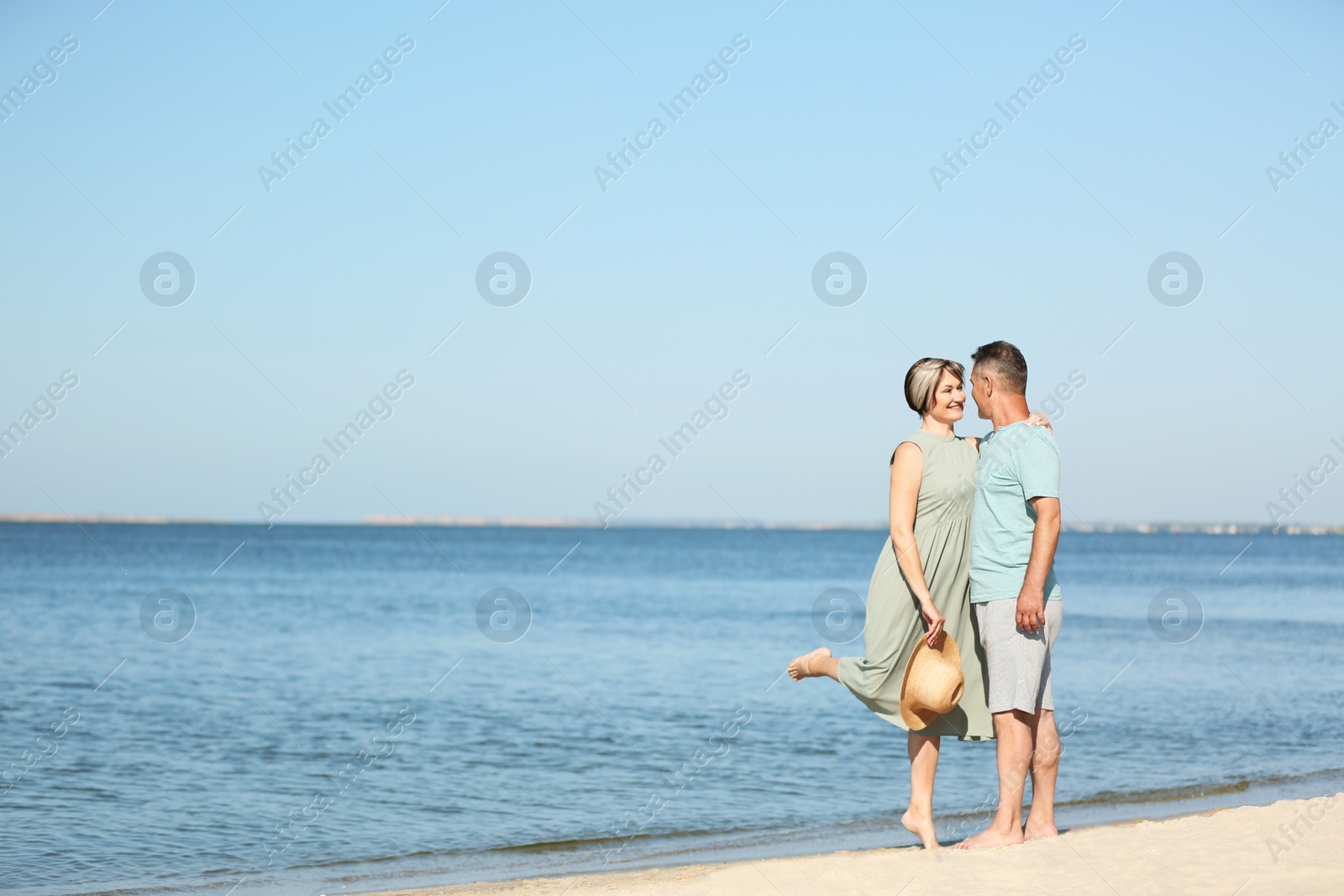 Photo of Happy mature couple dancing at beach on sunny day