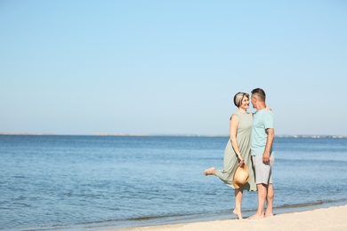 Photo of Happy mature couple dancing at beach on sunny day