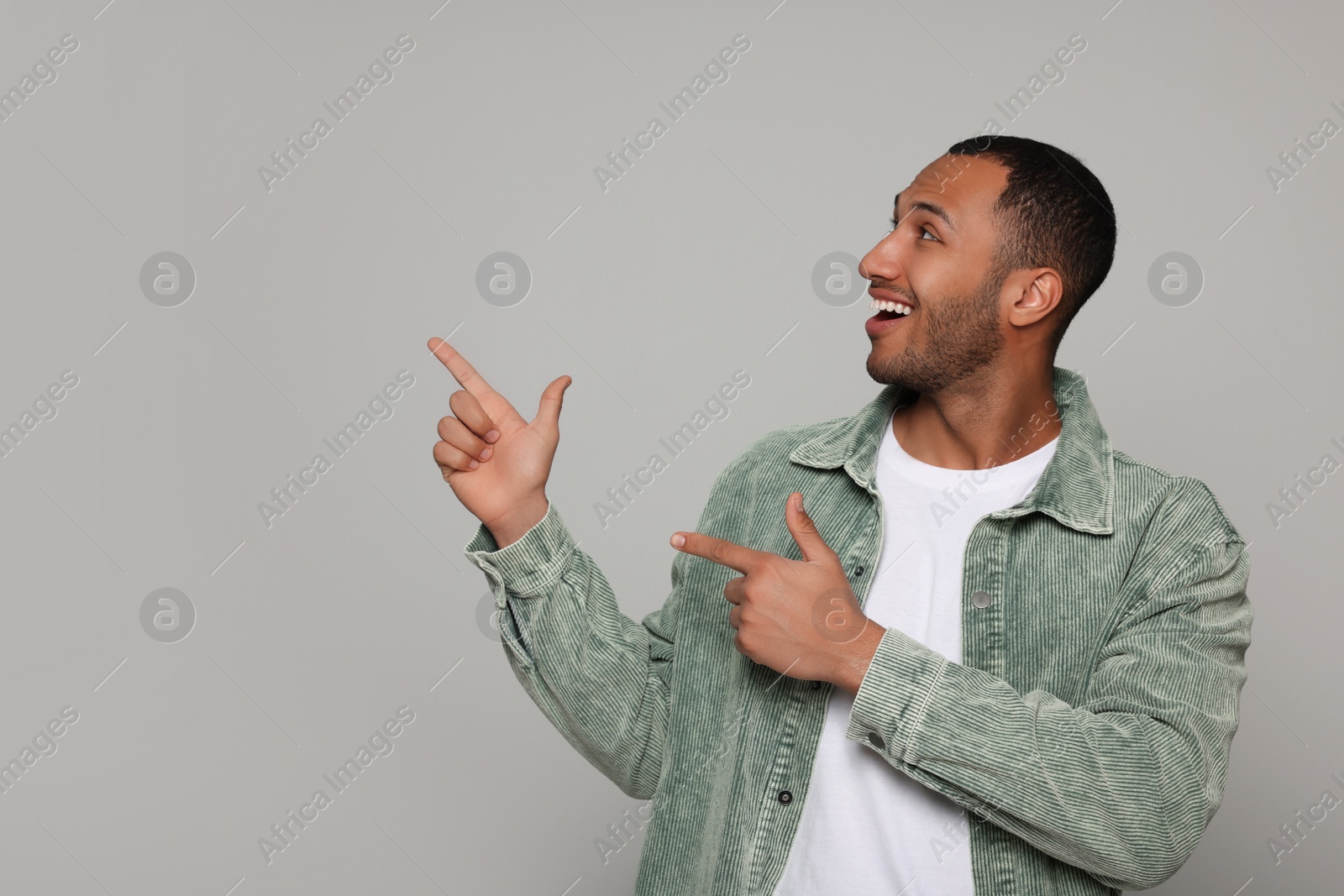 Photo of Portrait of smiling African American man on light grey background. Space for text