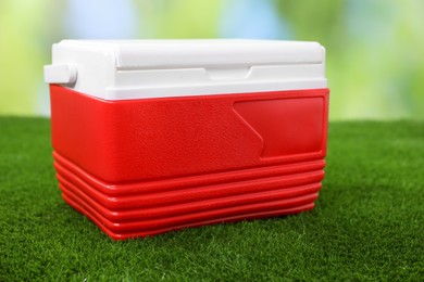 One plastic cool box on artificial grass, closeup