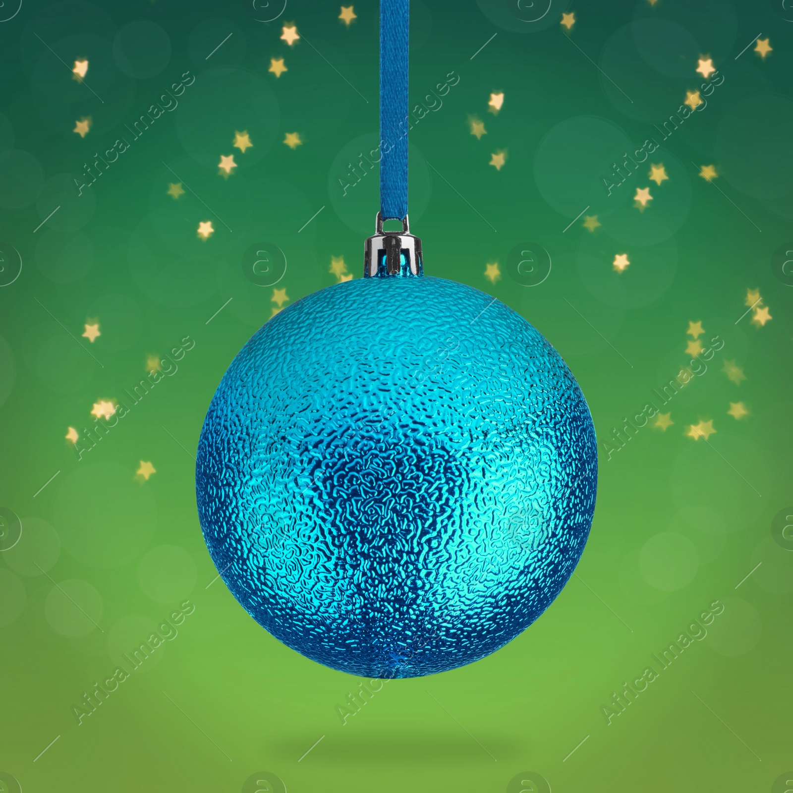 Image of Beautiful blue Christmas ball hanging on green background