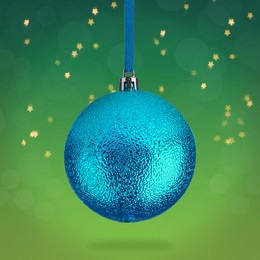 Image of Beautiful blue Christmas ball hanging on green background