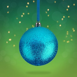 Beautiful blue Christmas ball hanging on green background