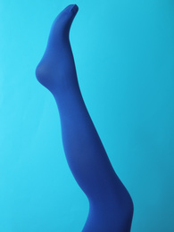 Photo of Leg mannequin in blue tights on color background