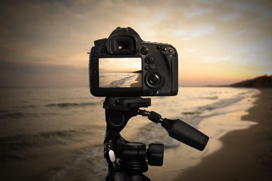 Taking photo of beautiful seascape with camera mounted on tripod