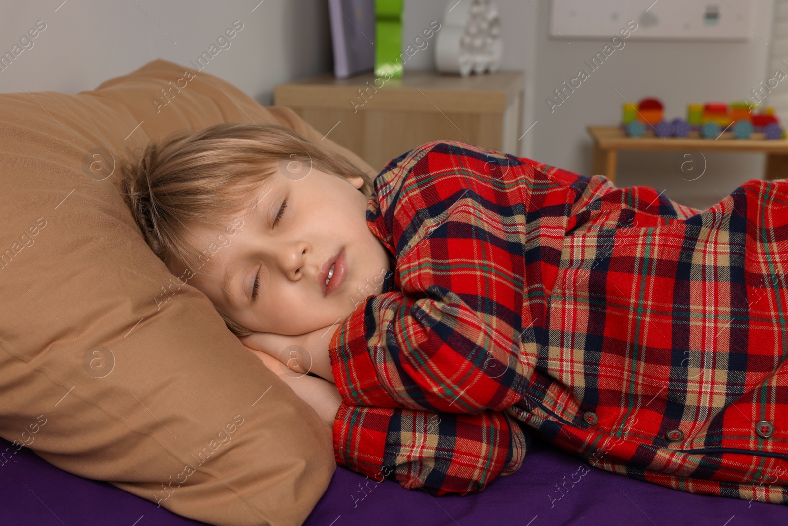 Photo of Little boy snoring while sleeping in bed at home