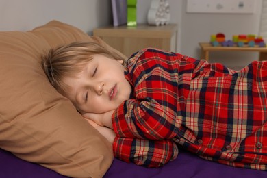 Photo of Little boy snoring while sleeping in bed at home