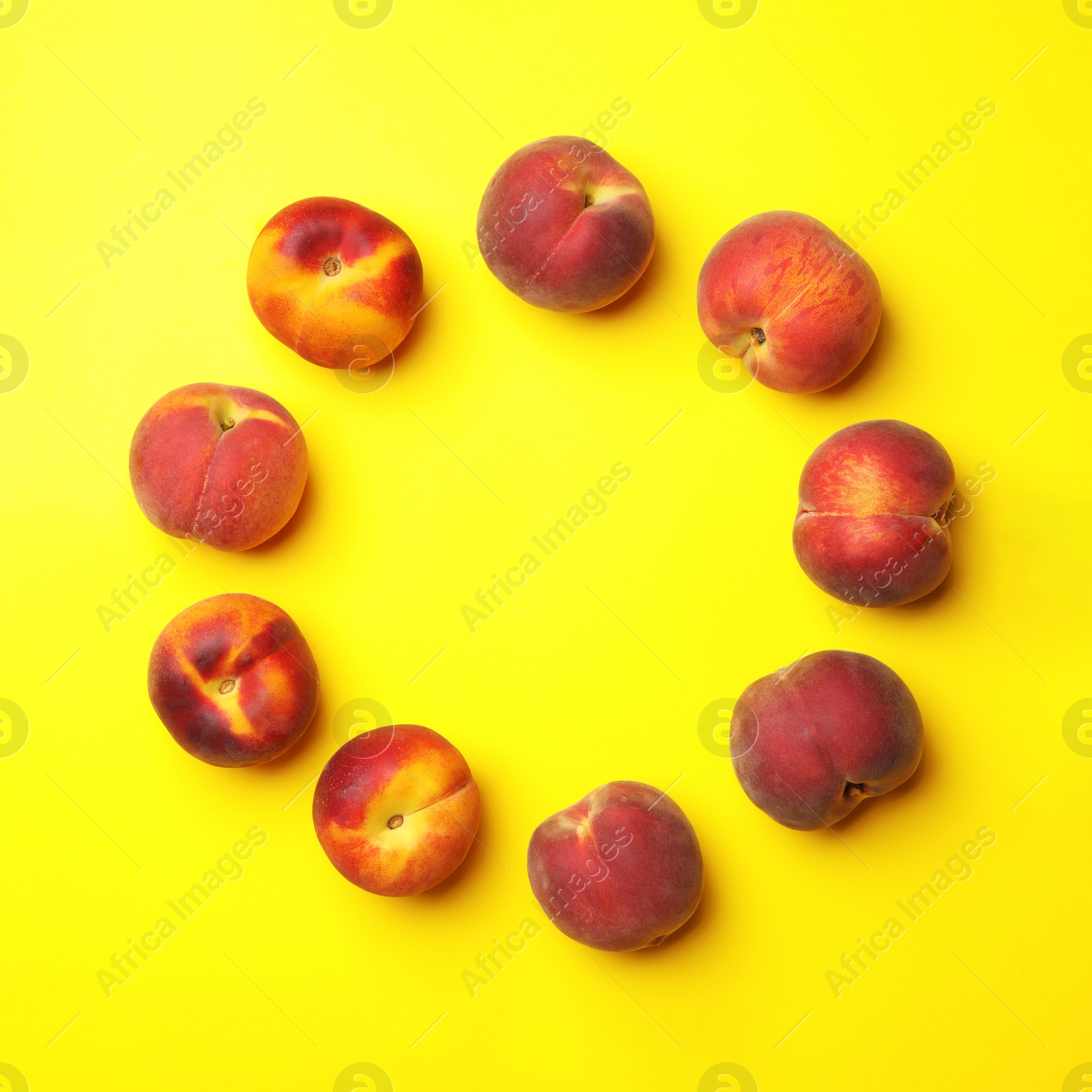 Photo of Flat lay composition with ripe peaches on yellow background, space for text