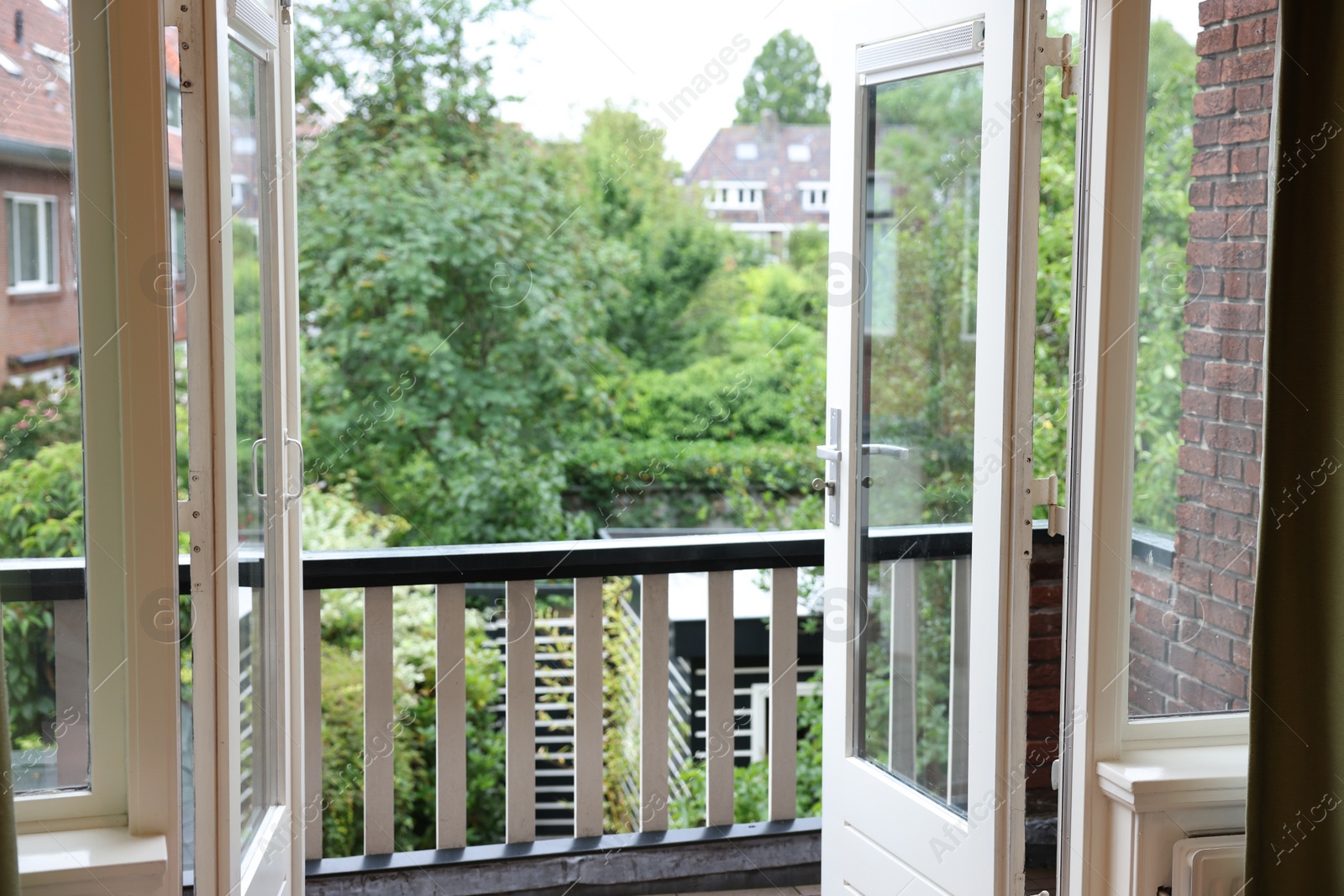 Photo of Beautiful view on balcony and inner yard with green trees from apartment