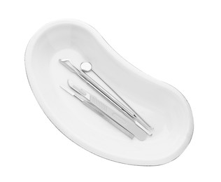 Photo of Kidney shaped tray with set of dentist's tools isolated on white, top view