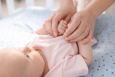 Photo of Mother with her cute little baby in crib