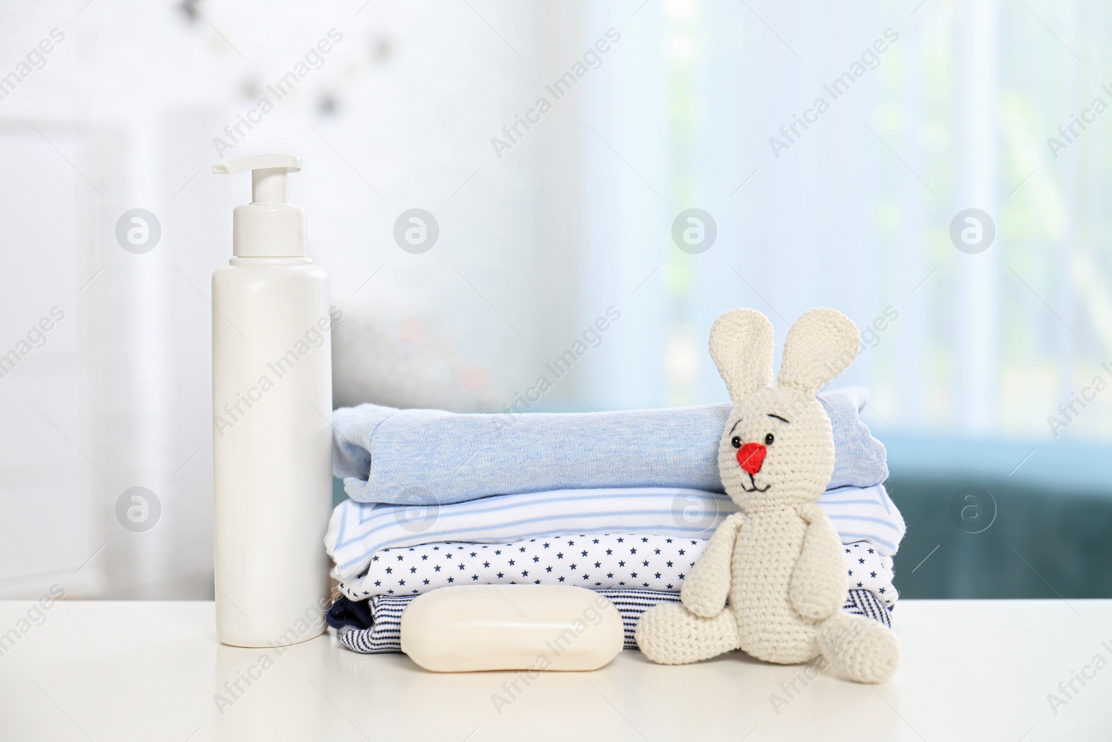 Photo of Baby accessories on table in nursery room. Space for text