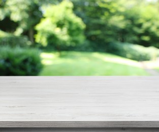 Image of Empty white wooden surface outdoors on sunny day. Space for design