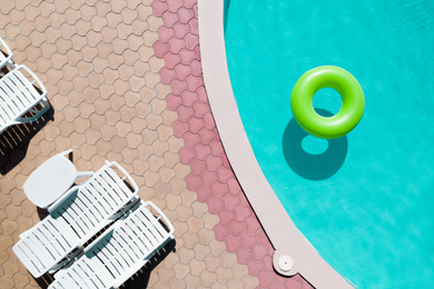 Inflatable ring floating in swimming pool, top view. Summer vacation