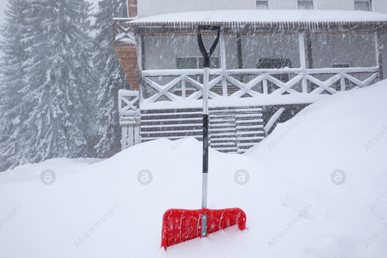 Photo of Snow cleaning shovel near house. Winter outdoor work