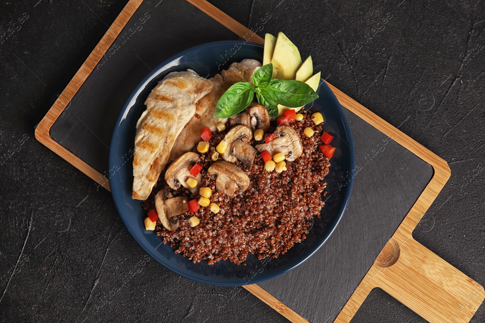 Photo of Plate with quinoa and garnish on table, top view